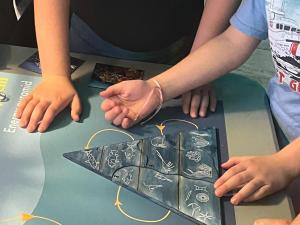 Children solving puzzles in the Escape Room